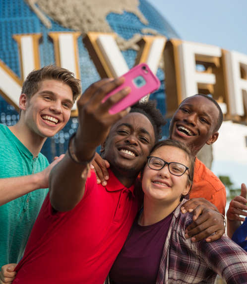 Happy group of diverse young people having fun and taking a selfie