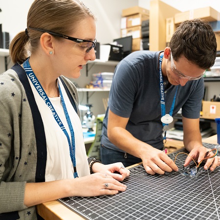 Two Team Members testing new technology in the Universal Creative design studio