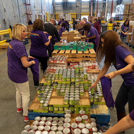 Team Members volunteer by sorting canned goods for food bank donations.