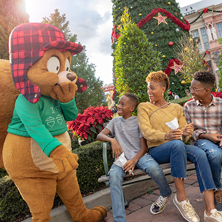 Earl the Squirrel laughing with three guests