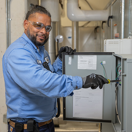 A Team Member working on a electrical breaker