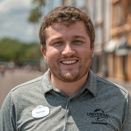 Entertainment Manager, Dalton, looking at the camera and smiling
