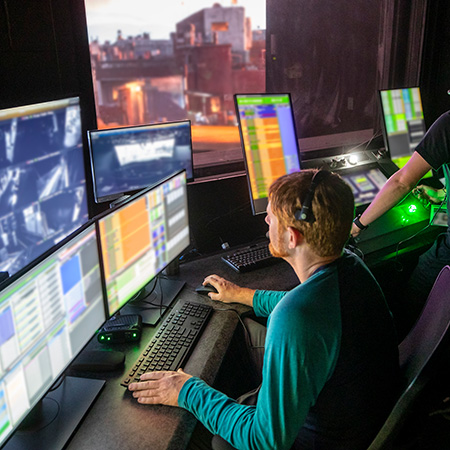 Technical Entertainment Team Member overseeing a show's controls