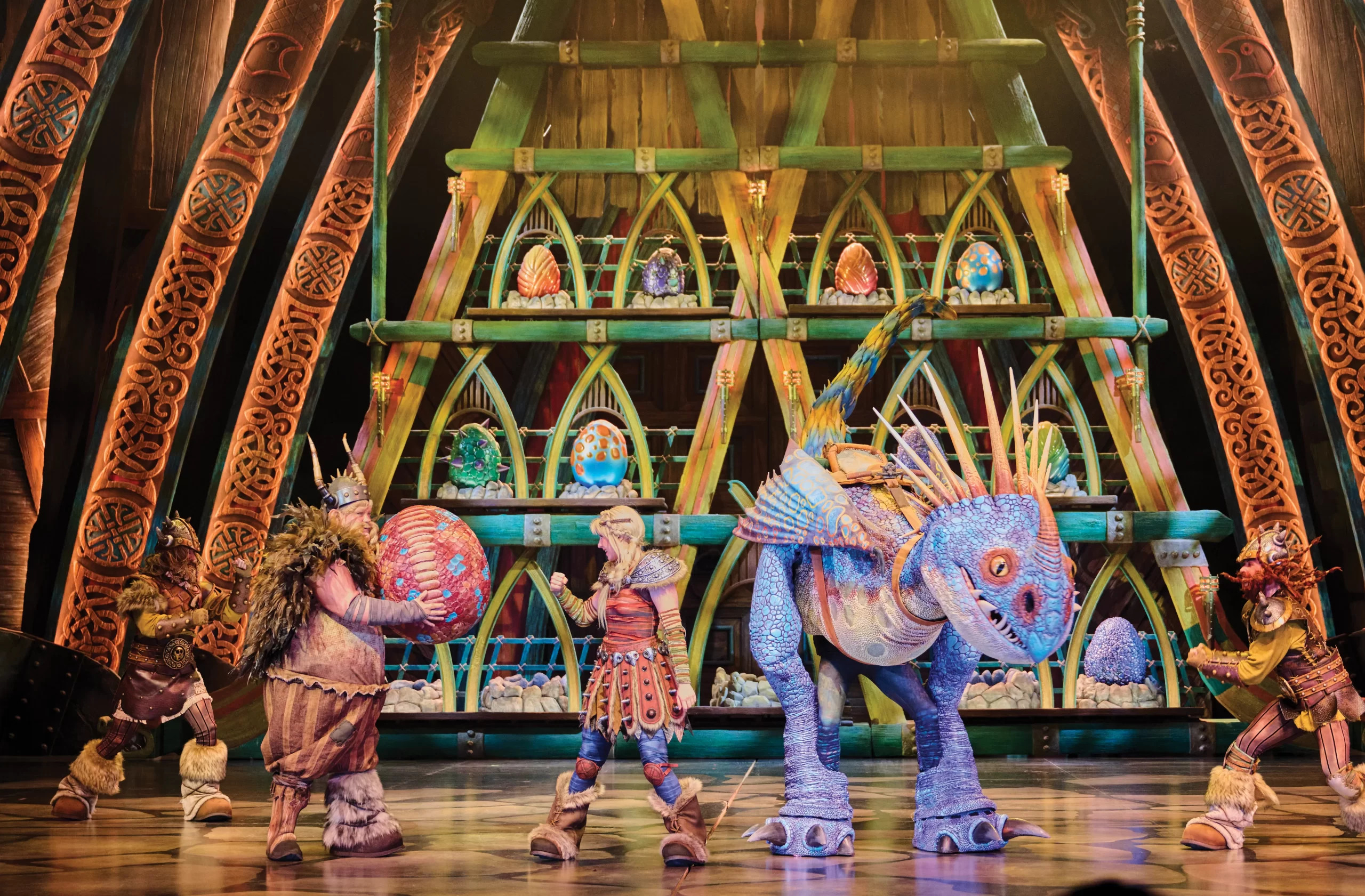 The Untrainable Dragon stage show at Epic Universe, several vikings and a Dragon pose on stage